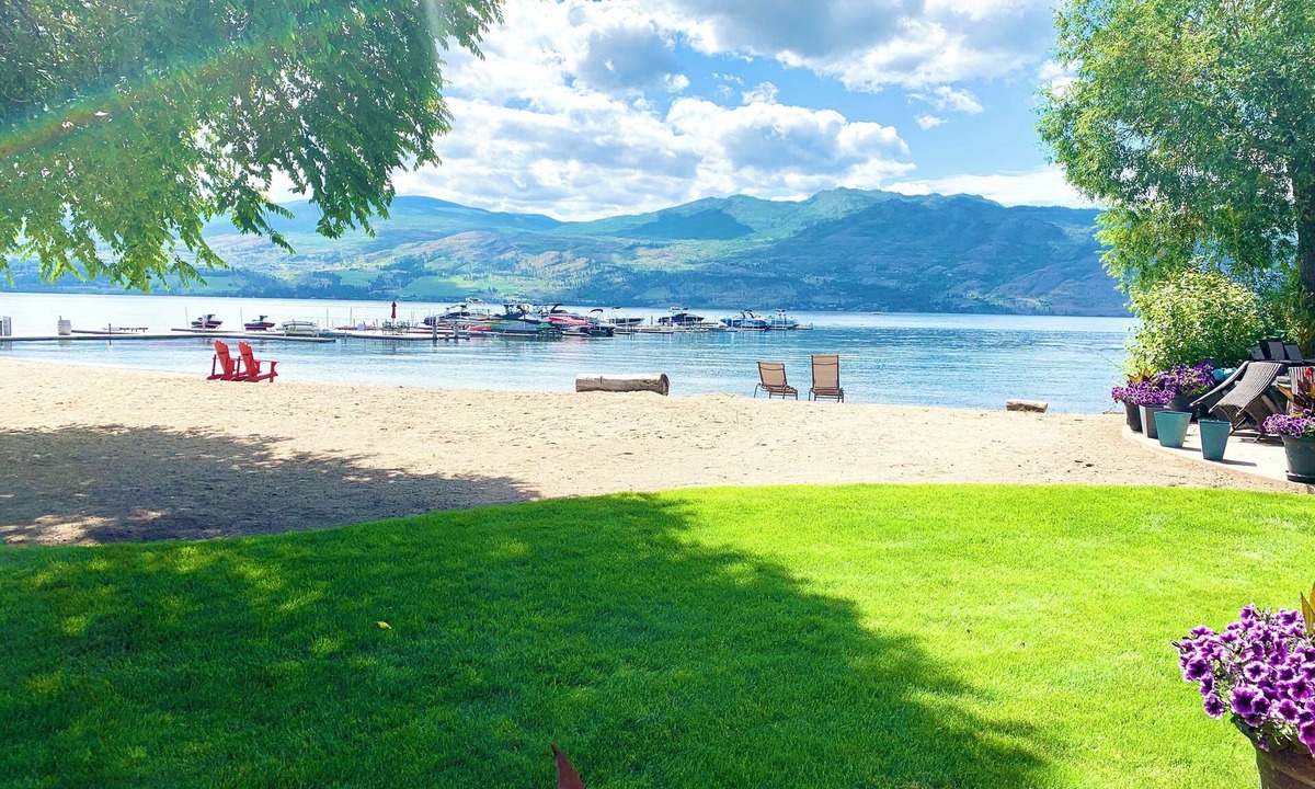 Central Okanagan Condo | Beachside Bliss! Spacious Ground Level Walk Out Patio Direct on the Beach & Lake