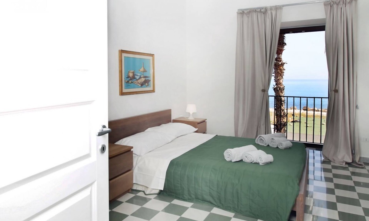 Marina di Caronia Apartment | Dimora Burrafato, known by locals as “La Casa Rossa”, is a historic summer residence once owned by Princess Pignatelli, located directly on the seafront of Caronia. The property consists of three independent units, each with a private entrance, a bal