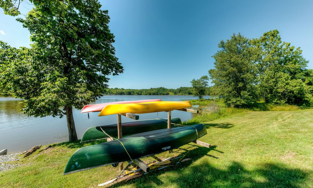 Orange House | Two-story, lakefront getaway with dock, beach, grill, 2 kayaks, 2 canoes, AC