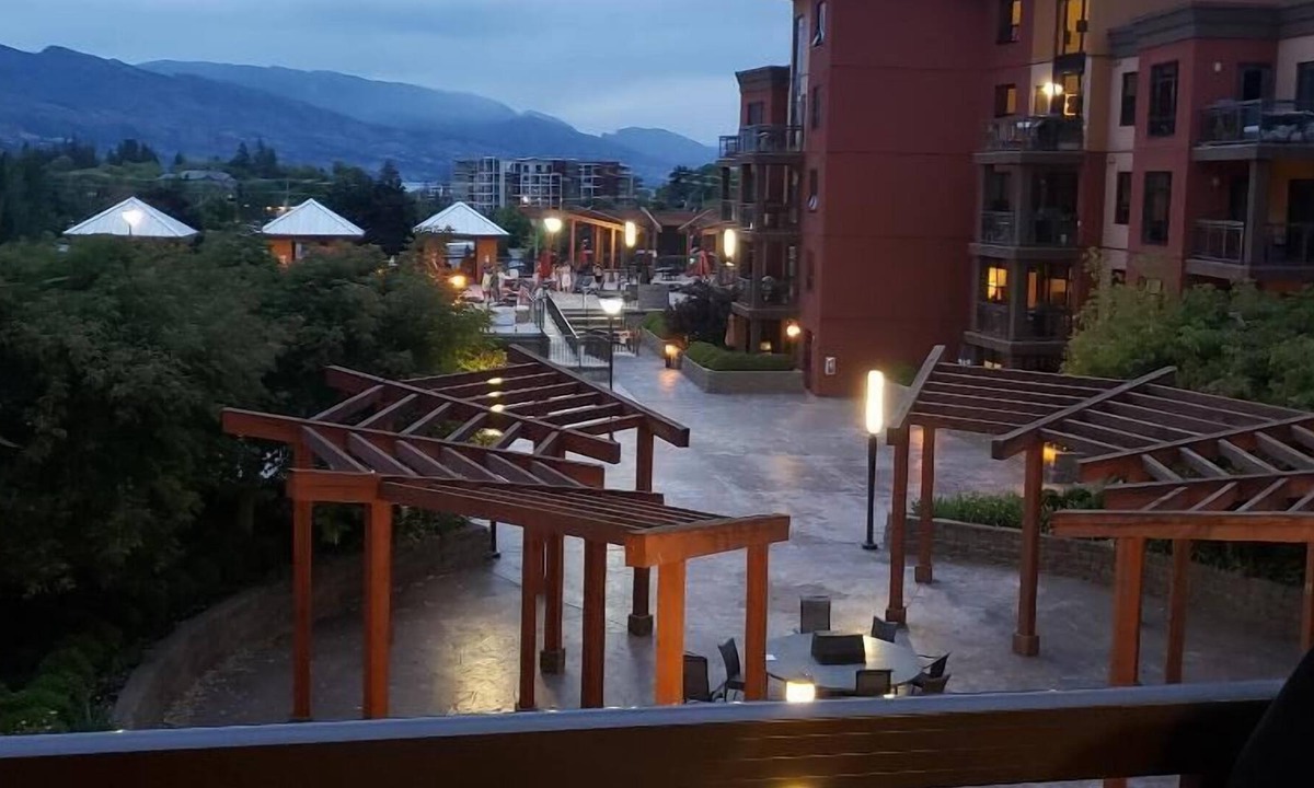 South Pandosy Condo | View of a courtyard with a pool and view of the mountains