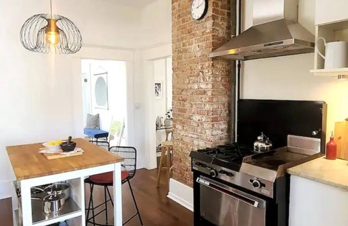 East Side House | Design Heritage Suite | Brick + Private Patio near Commercial Drive