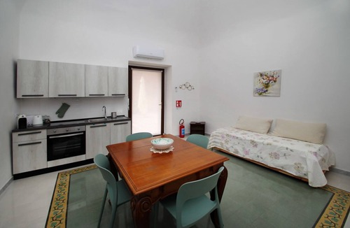 Marina di Caronia Apartment | Dimora Burrafato, known by locals as “La Casa Rossa”, is a historic summer residence once owned by Princess Pignatelli, located directly on the seafront of Caronia. The property consists of three independent units, each with a private entrance, a bal