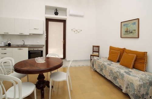 Marina di Caronia Apartment | Dimora Burrafato, known by locals as “La Casa Rossa”, is a historic summer residence once owned by Princess Pignatelli, located directly on the seafront of Caronia. The property consists of three independent units, each with a private entrance, a bal