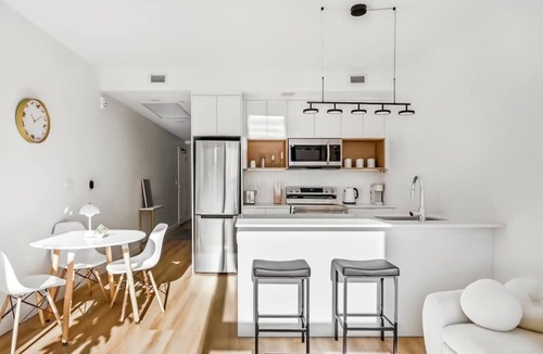 Mount Pleasant Apartment | Elegant Calgary Abode: Fitness Studio, Sauna, Billiards.