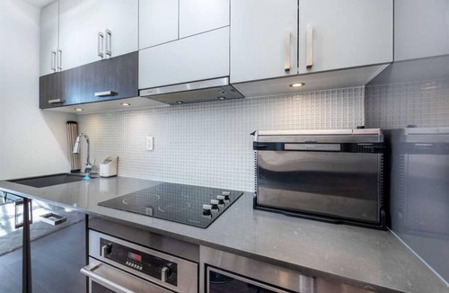 East Village Condo | Executive 1-Bed + Office Loft – Prime Riverfront, Gym, Near Stampede & City Life