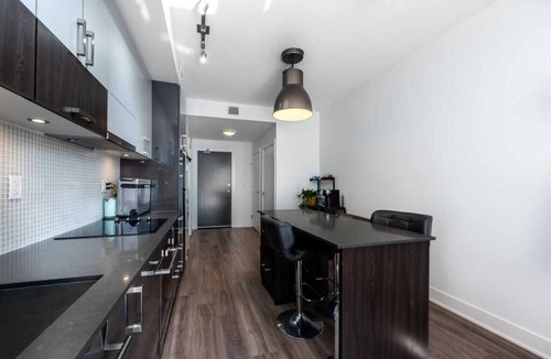 East Village Condo | Executive 1-Bed + Office Loft – Prime Riverfront, Gym, Near Stampede & City Life