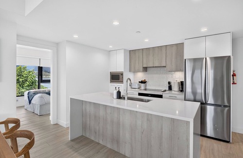 South Pandosy Apartment | Experience luxury waterfront living at Aqua Waterfront Village. This stylish 2BR, 2BA condo features designer interiors, two queen bedrooms, a spacious covered patio, chef's kitchen, and resort-style amenities just steps from Okanagan Lake.