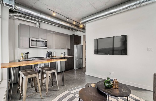 East Village Apartment | Industrial 1BR w Office, Views, AC, XL Patio