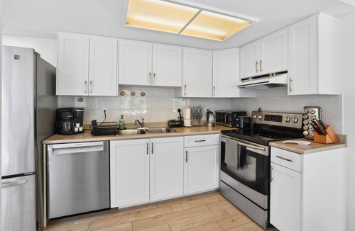 Upper Lonsdale House | Large fully renovated 2-bedroom ground-level suite with a fenced backyard