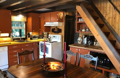 Cap-Pele Ski Chalet | Luxurious secluded rustic wooden chalet on edge of tranquil pond next to beach.