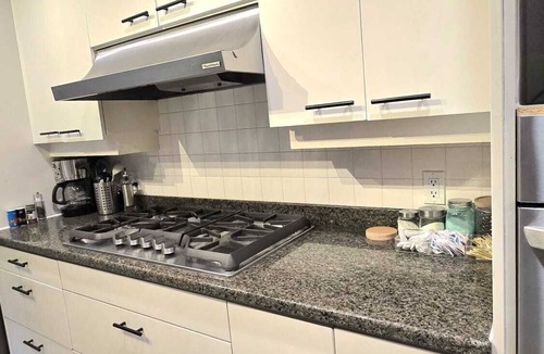 Upper Lonsdale House | Master bedroom with en-suite bathroom, and a shared kitchen and living room
