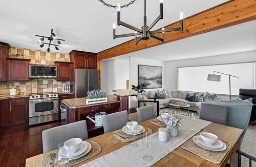 Central Okanagan House | Relax at a central Kelowna pool house with a private backyard oasis, outdoor bar & spacious layout over two levels. Walk or take a short drive to downtown cafés, shops, beaches & wineries, then come home to a quiet, stylish space.