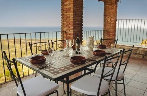Acquedolci Villa | Villa Caterina is situated on a rock and surrounded by extensive countryside. Wooden ceilings, stone walls and antique Sicilian decorations define the character of this impressive villa.The villa consists of a large living room with a fireplace, a spacio