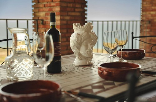 Acquedolci Villa | Villa Caterina is situated on a rock and surrounded by extensive countryside. Wooden ceilings, stone walls and antique Sicilian decorations define the character of this impressive villa.The villa consists of a large living room with a fireplace, a spacio