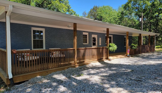 Charming brick home set in the woods on 45 acres with pond and trails.