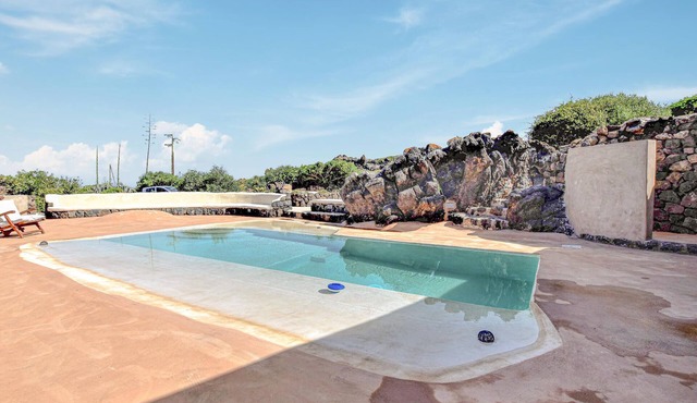 Picturesque vacation home with pretty pool and panoramic sea view.