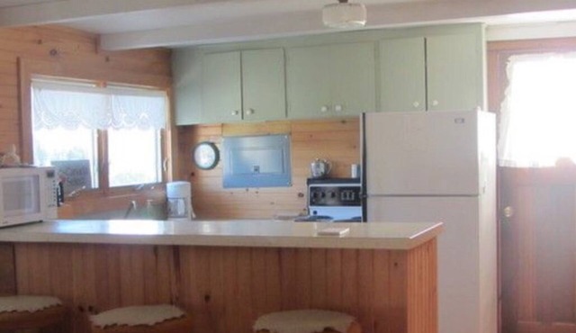 Two Bedroom Cottage With Open Concept Leading To Large Patio And Screened Porch.